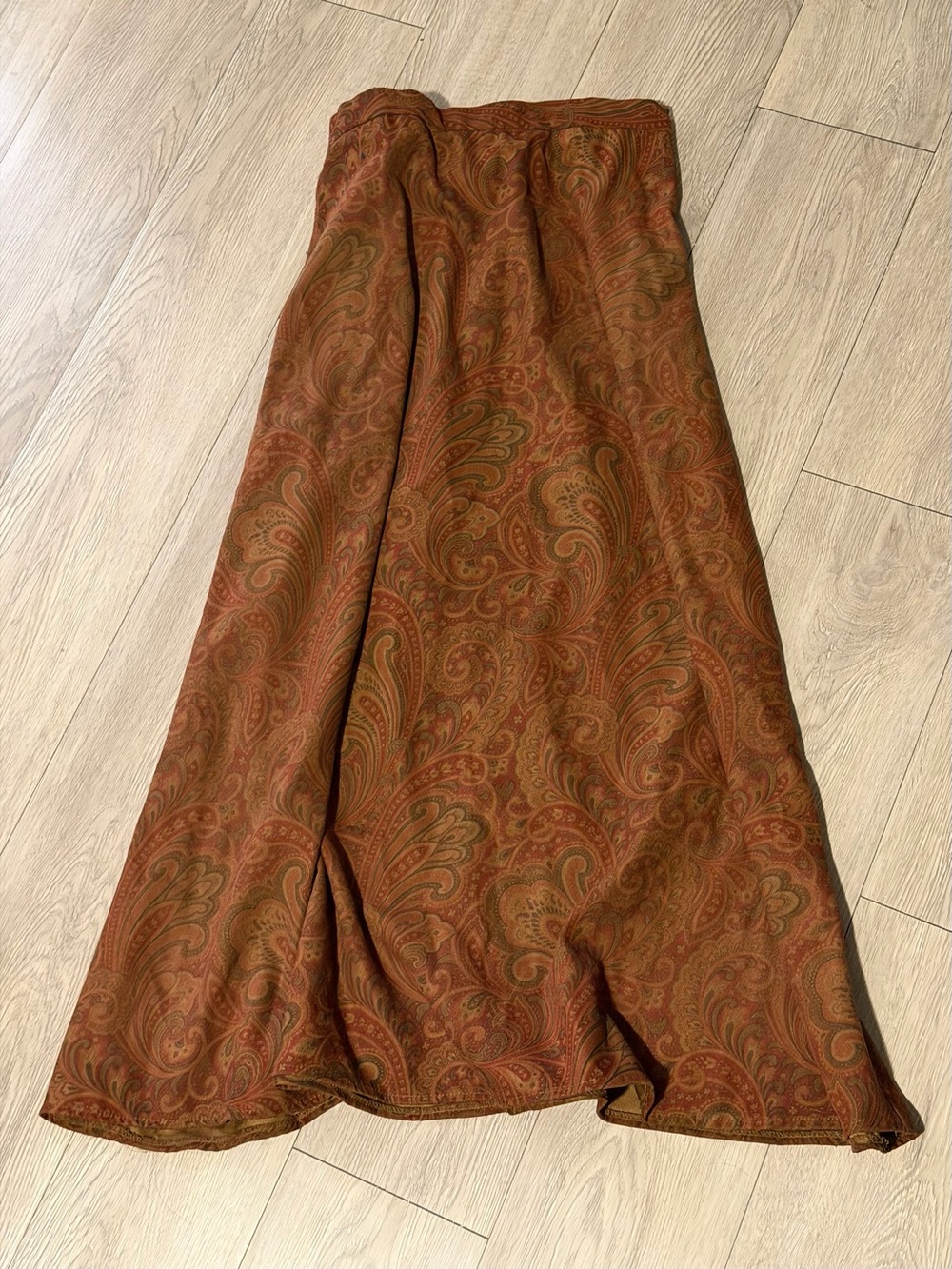 Brown paisley maxi skirt with elastic waistband and pockets.